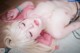 A woman with pink hair laying on the floor.