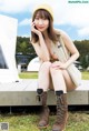 A woman sitting on a bench talking on a cell phone.