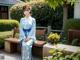 A woman in a blue kimono sitting on a bench.